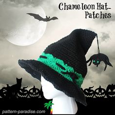 a crocheted hat with a green dragon on it and bats in the background