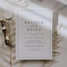 the brunch and the bride wedding stationery is laid out on a table