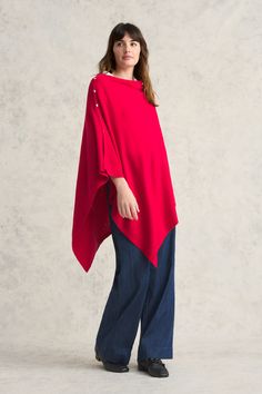 This poncho wrap is made from a luxurious blend of Australian Merino wool and cotton in rich Rouge. Both lightweight and warm, it is the perfect transeasonal layering piece for cooler days and nights. Adorn your poncho with your favourite whimsical brooch et voilà! Chic One-size Cape Poncho, Chic One Size Cape Poncho, Winter Cashmere Poncho One Size, One Size Cashmere Poncho For Fall, Oversized Cashmere Poncho For Winter, Oversized Cashmere Cape With Long Sleeves, Oversized Wool Poncho For Layering, Oversized Cape Wraps For Winter, Oversized Winter Cape Wrap