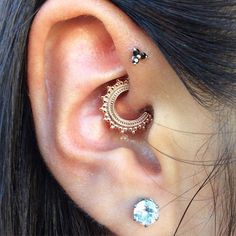 an ear with two piercings attached to it