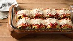 lasagna rolls in a casserole dish with sauce and cheese