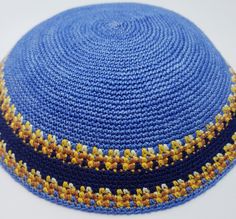 A truly classy sky blue Yarmulke Kippah Hat has a simple yet beautiful clean geometric pattern. This sky blue Knitted Kippah features bright yellow and green stripes above and below with a navy blue band that runs across the center of it and a sky blue border on its edge. This Hand Knitted design has been the most loved pattern and has always outperformed. One of the most loved Kippah, it is made with top-quality threads which are tightly knitted to give it a long life. This simple and elegant U Traditional Fitted Blue Hat, Handknit Design, Bar Mitzvah Party, Knitted Design, Basic Embroidery Stitches, Blue Border, A Sky, Blue Band, Yellow And Green