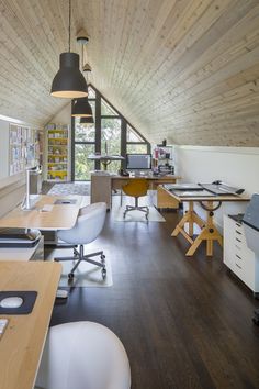 an office with wood floors and white desks