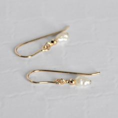 These delicate, classic earrings are made with small fresh water pearls, paired with 2mm 14 karat gold filled beads and coupled with 14 karat gold filled wire and ear wires. Due to the nature of fresh water pearls, each is unique in size and shape and will vary slight from the pictures. They are understated with a simple elegance to them. Dainty Everyday Pearl Earrings In 14k Gold, Dainty 14k Gold-filled Pearl Charm Earrings, Dainty 14k Gold-filled Pearl Earrings For Everyday, Dainty 14k Gold Filled Pearl Earrings For Everyday, Dainty Hypoallergenic 14k Gold-filled Pearl Earrings, Dainty 14k Gold Pearl Drop Earrings, Dainty 14k Gold Filled Pearl Earrings, Dainty 14k Gold Pearl Earrings, Pearl And Gold Earrings