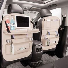 the back seats of a car with bottles and other items on it's trays