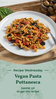 a white plate topped with pasta and vegetables