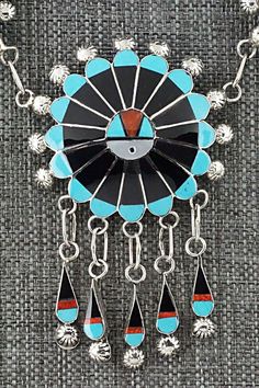 This Zuni Sunface set featuring turquoise, onyx, mother of pearl, coral, opalite and sterling silver inlay necklace, earrings, ring and bracelet was made by Zuni silversmith Abel Soseeah. The set is signed.Necklace: 18"Pendant Length: 2 5/8"Pendant Width: 1 3/4"Earrings:Length: 2 3/4"Width: 1 1/4"Bracelet:Size: 5 5/8" (will fit up to a 6 5/8" wrist)Gap: 1"Width: 1 5/8"Ring:Size 7.5Width: 1 1/4Length: 1 1/4Free shipping on all orders! We ship with USPS and always include tracking. All orders ship Southwestern Jewelry With Inlay For Gifts, Southwestern Style Jewelry With Inlay For Gift, Traditional Black Jewelry With Polished Finish, Southwestern Style Inlay Jewelry As Gift, Sterling Silver Artisan Jewelry With Inlay, Artisan Sterling Silver Inlay Jewelry, Artisan Sterling Silver Jewelry With Inlay, Adjustable Artisan Jewelry With Inlay, Black Sterling Silver Jewelry With Inlay