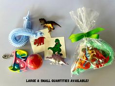 some toys are laying out on a table with the words large and small quantities available