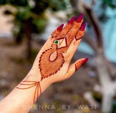 a woman's hand with henna painted on it