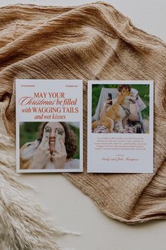 two wedding cards on top of a blanket next to a furnishing bag with a dog