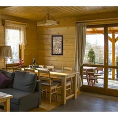 a living room filled with furniture and wooden walls