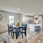 a kitchen and dining room with wood flooring in an open concept home, which has been recently remodeled