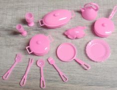 pink plastic kitchen utensils and accessories laid out on a table