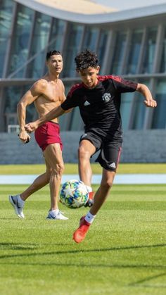 two men are playing soccer on the field