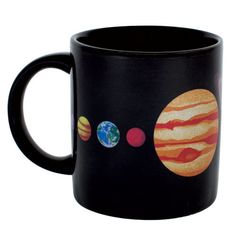 a black coffee mug with the planets on it