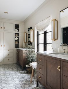 a bathroom with white walls and brown cabinets