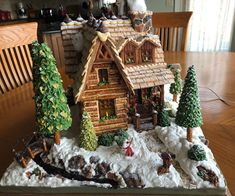 a wooden table topped with a small christmas village