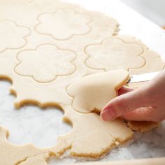 a person cutting out dough with a knife