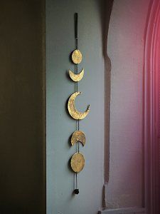 the gold moon chime is hanging on the wall