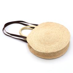 a round straw bag on a white background