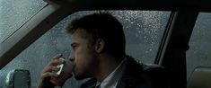 a man sitting in the back seat of a car while talking on a cell phone