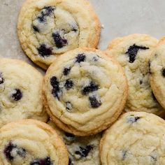 a pile of blueberry cookies sitting on top of a table