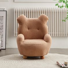 a teddy bear chair sitting on top of a rug in front of a radiator