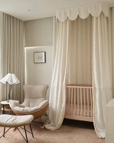 a baby's room with a crib, rocking chair and curtains