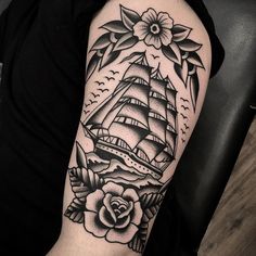 a black and white photo of a ship with roses on it's arm,