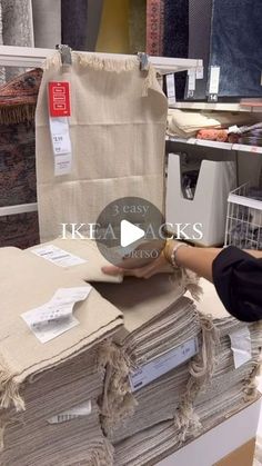 a person is stacking up linens in a store