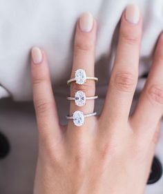 a woman's hand with three rings on it