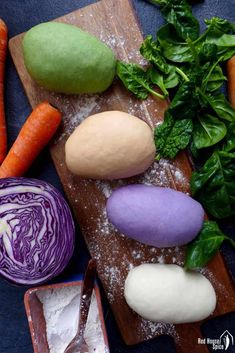 an assortment of vegetables on a cutting board