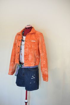 Item # 210579 DETAILS: Upcycled Orange Denim Jacket. This jacket is a size  "Calvin Klein" brand,  100% Cotton Trucker Style Jacket dyed orange.  It is a 6 blue button trucker jacket with 2 flap front breast pockets and button cuff sleeves.  Boys Size Medium Measurements:  15" across the shoulders,  19" from collar seam to hem,  18" from armpit to armpit (36" chest) 17" at the waistline, (34" waist) 25" sleeve length.  38 cm across the shoulders,  48 cm from collar seam to hem,  46 cm from armpit to armpit (92 cm chest) 43 cm at the waistline, (86 cm waist) 64 cm sleeve length.  Jacket sizes may vary. I recommend that you measure a jacket that you have and compare the measurements.  The jacket has been dyed with fabric dye and will not rub off onto other clothing. The jacket has been washe Acid Wash Cotton Denim Jacket, Fitted Acid Wash Denim Jacket For Spring, Casual Fitted Pre-washed Denim Jacket, Fitted Acid Wash Cotton Outerwear, Fitted Faded Cotton Outerwear, Spring Outerwear Relaxed Fit Pre-washed, Spring Outerwear: Pre-washed Relaxed Fit, Spring Relaxed Fit Pre-washed Outerwear, Denim Belt