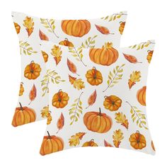 two pillows with pumpkins and leaves on them