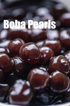 a bowl filled with chocolate covered cherries on top of a wooden table next to text that reads, boba pearls