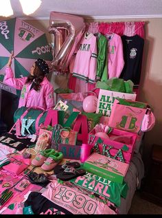 a table topped with lots of pink and green items