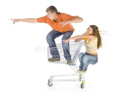 two people are sitting in a shopping cart and pointing at something on the floor royalty images