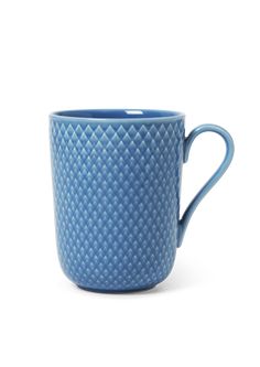 a blue coffee cup sitting on top of a white table