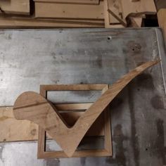 a piece of wood sitting on top of a metal table next to a wooden box