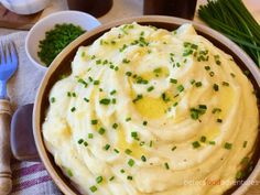 mashed potatoes in a bowl with chives on the side