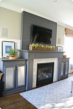 a living room with a fireplace and tv above it