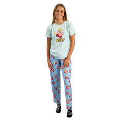 Elevate your relaxation game with this officially licensed Kirby Adult Juniors Sleepwear Set. This set includes a comfortable light blue short sleeve tee shirt crafted from a blend of 60% cotton and 40% polyester for a soft and breathable feel. The tee shirt showcases everyone's favorite video game hero, Kirby, front and center, adding a pop of fun to your loungewear. Accompanying the tee shirt are light blue sleep pants that feature an all-over repeat print of Kirby surrounded by playful stars. Playful Blue T-shirt For Loungewear, Casual Graphic Print T-shirt For Pajama Party, Casual Cotton T-shirt For Bedtime, Light Blue Casual Sleepwear, Casual Light Blue Sleepwear, Light Blue Casual Sleepwear For Loungewear, Casual Light Blue Sleepwear For Loungewear, Casual Short Sleeve Sleepwear For Sleepover, Light Blue Casual Sleepwear For Sleepover