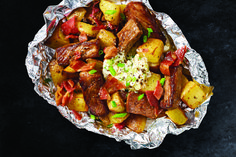 some food that is on top of tin foil and sitting on a black countertop