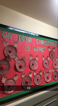 a bulletin board with handprints on it that says oh deer, christmas is here