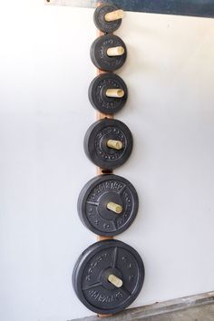 the barbells are lined up against the wall