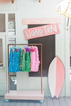 there is a surfboard on display in front of the hang ten sign and other items