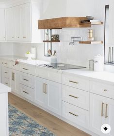 a kitchen with all white cabinets and wood counter tops is pictured in this image from the front view