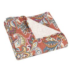 an orange and blue paisley print blanket on a white background