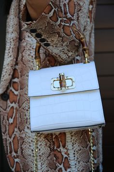 White croc-embossed top handle mini bag. Front view. Bamboo handle with bamboo clasp and gold-toned hardware. Gold chain shoulder strap. Mini Handbag, Mini Handbags, Top Handle