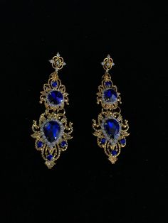 Royal Blue Earrings Wedding Sapphire Bridal Gold metal Crystals Baroque Woman Byzantine Queen wedding LARGE Teardrop Drop Estate Style Earring Allow yourself to be unique! All my products are only handmade Be nothing short of a queen on your wedding day! Style it with a gorgeous updo or let your hair down for a princess' look - whatever your hairstyle, you are guaranteed to have all eyes on you on your special day. A stunning accessory that also looks amazing in bridal photo shoots. Crown comple Royal Gold Jewelry For Formal Occasions, Gold Jeweled Bridal Earrings For Wedding, Elegant Blue Chandelier Earrings For Wedding, Wedding Filigree Chandelier Earrings, Elegant Blue Earrings For Party, Intricate Metal Earrings For Weddings, Royal Blue Jewelry For Wedding, Ornate Metal Earrings For Wedding, Blue Teardrop Chandelier Earrings For Wedding